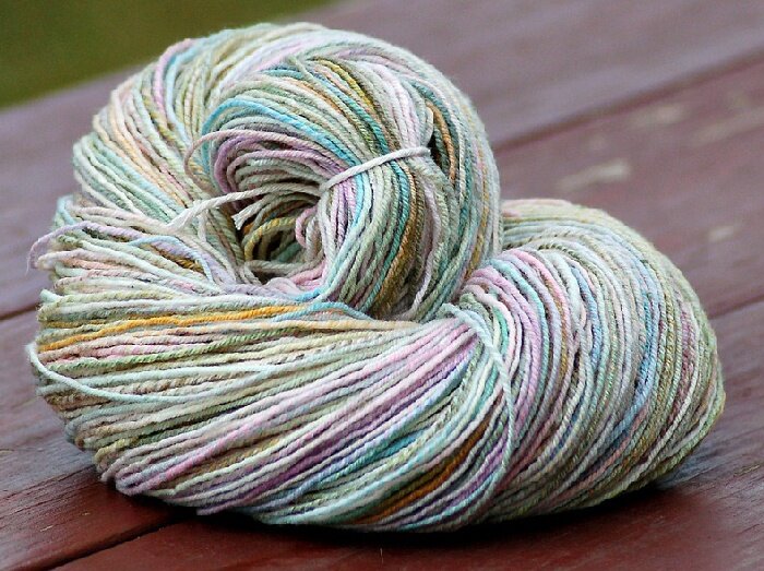 A ball of yarn in pastel tinted colors.